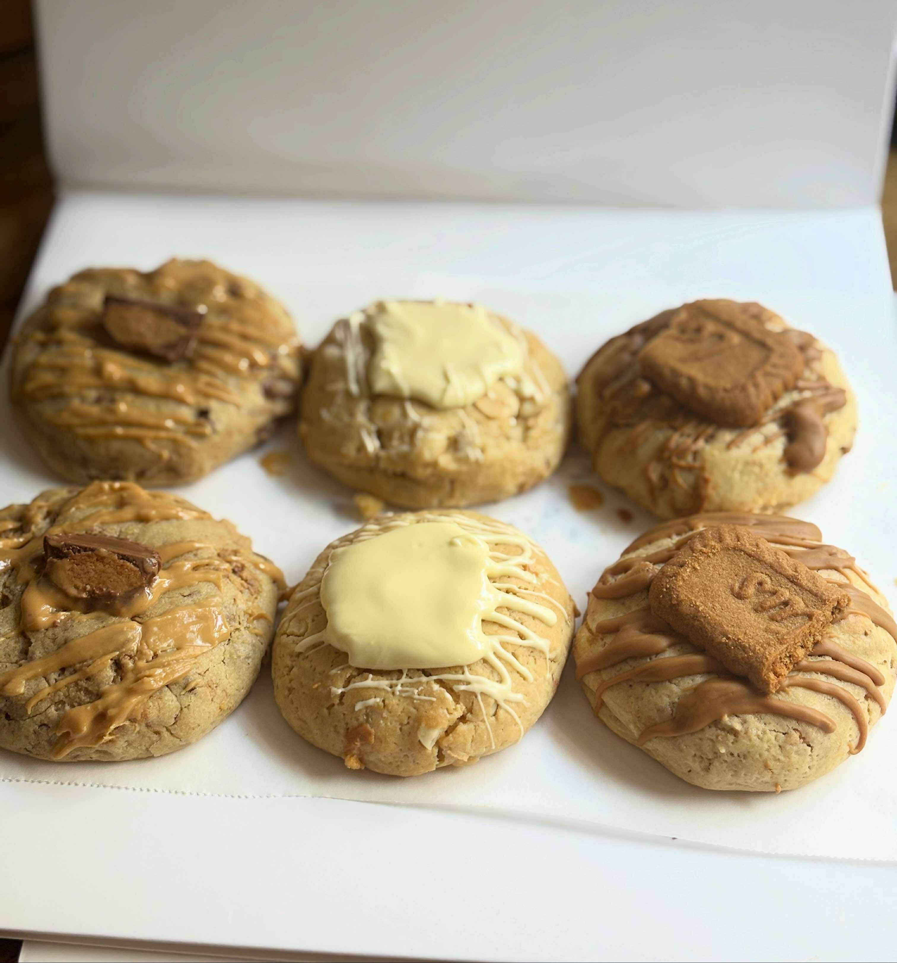 Six cookies with different fillings on a white surface